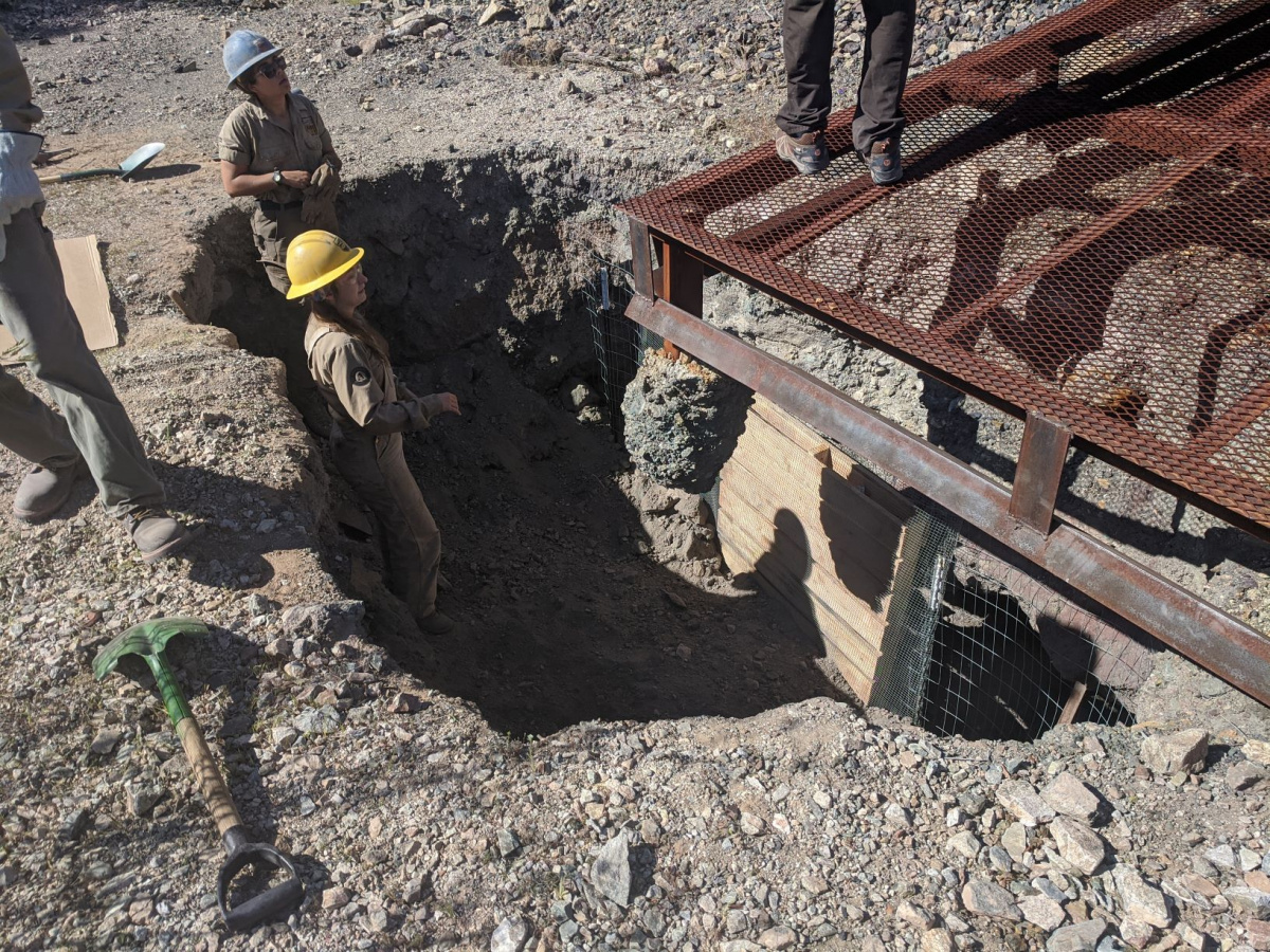 crew members in a hole caused by erosion