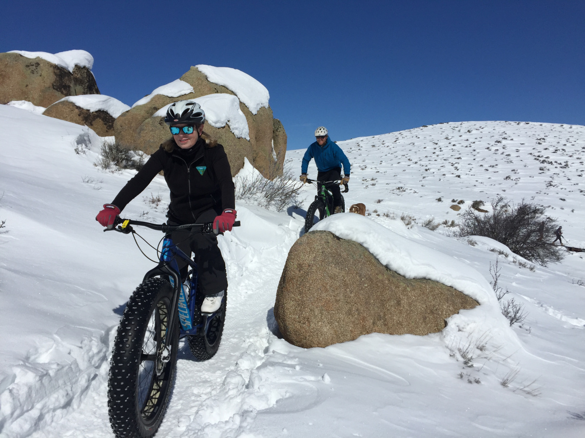 people fat tire biking on snow