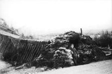 man standing outside sod guard hut