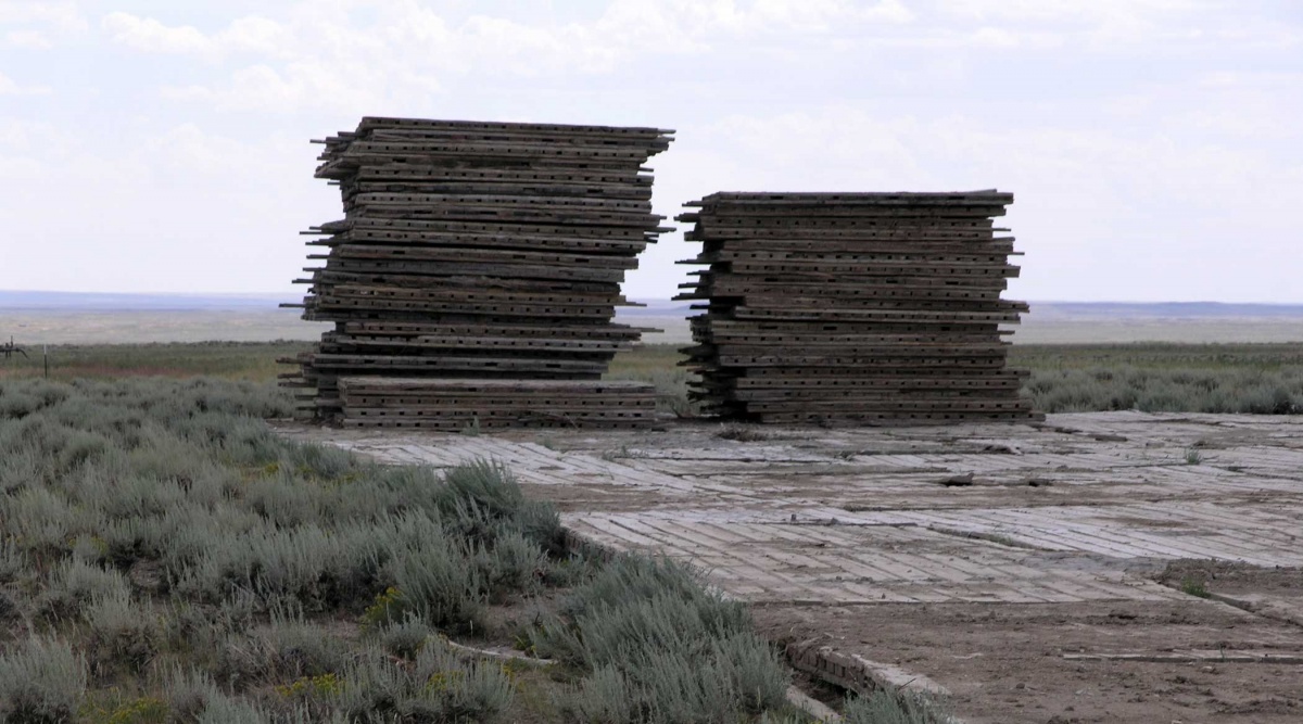 Two large piles of wooden oak mats sit on a wooden platform. Photo by Jim Perry.