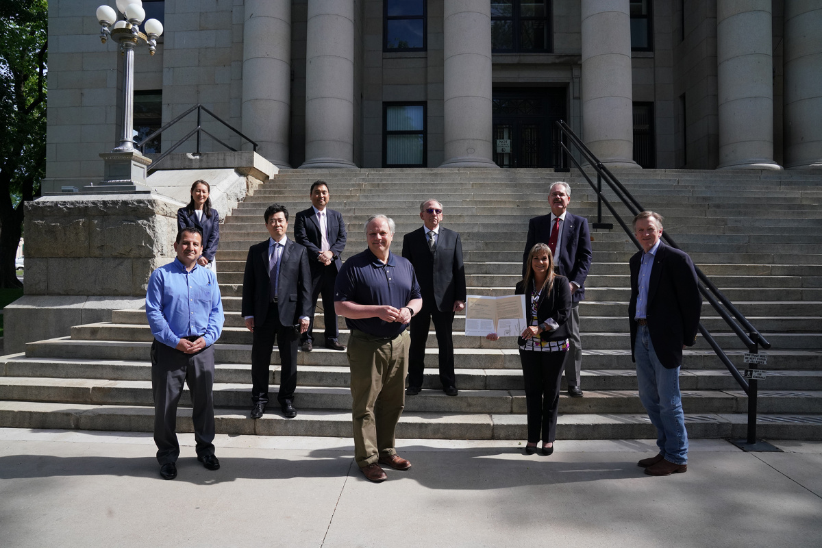 a group of people stand on courthouse steps