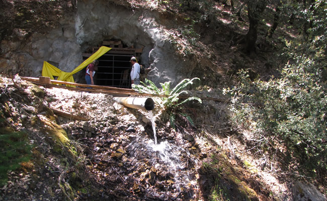 Water drains from a pipe and flows down the side of a mountain. Photo by Peter Graves, BLM.