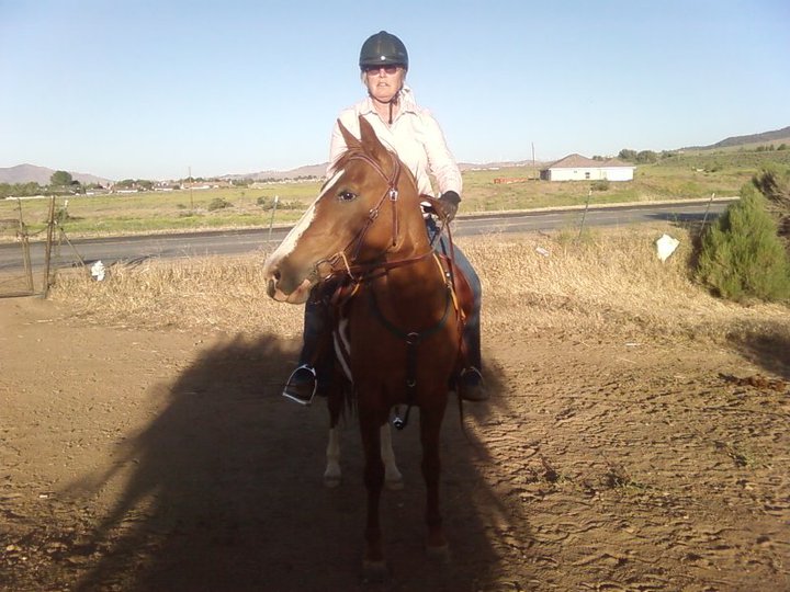 Woman on brown horse. 