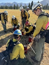 student firefighters working with drip torches