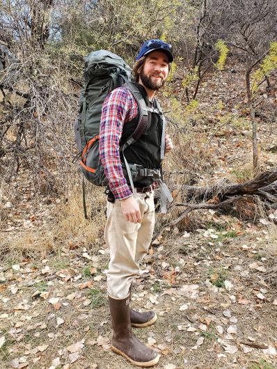 a volunteer wears a backpack