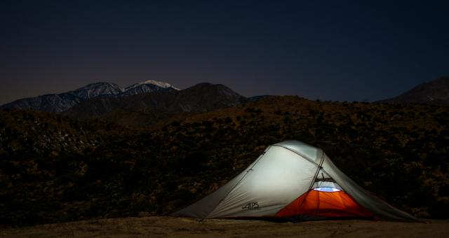 Lit tent against a nightsky