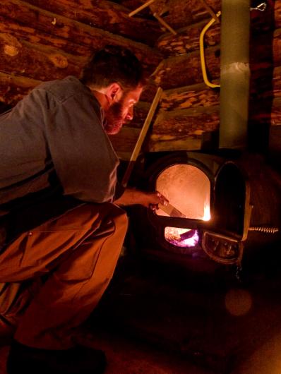 Man loading wood stove