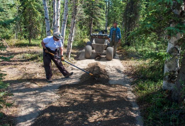 Woman spreading gravel