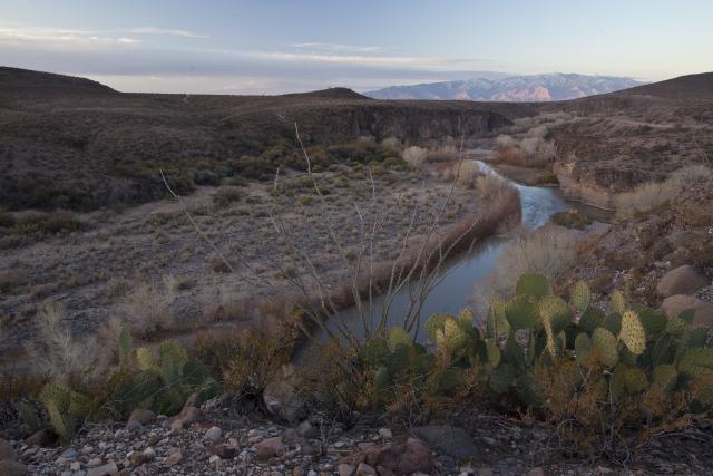 Looking down on a canyon with a river flowing through it.