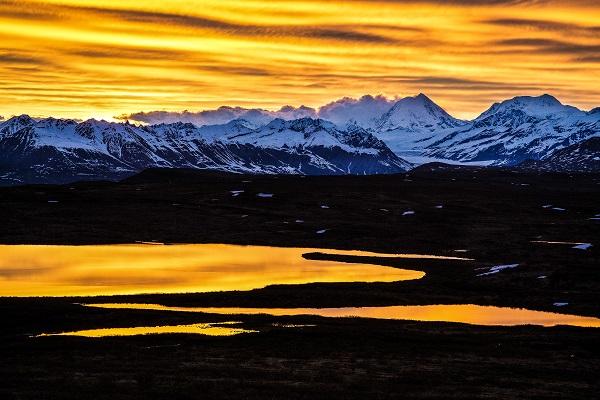 Bob says: "This photo taken in Alaska was one of my favorite photo experiences. In the lower 48 a twilight glow after sunset lasts about 15 or 20 minutes.  Here along the Denali Highway, I sat up all "night" and watched the twilight continue for several hours before the sun rose.  View is of Mount Hayes: At 13,800 feet it is one of the highest mountains on BLM-managed lands." (Photo by Bob Wick)