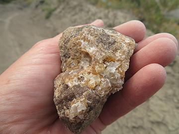 Hand holding a piece of calcite