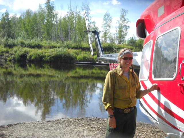 Woman standing next to helicopter