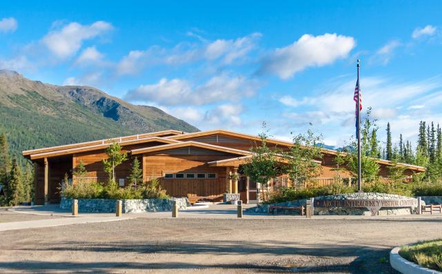 Photo of a wooden building with American Flag out front.