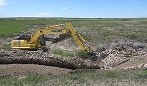 Heavy equipment is being used to dig up the ground. 