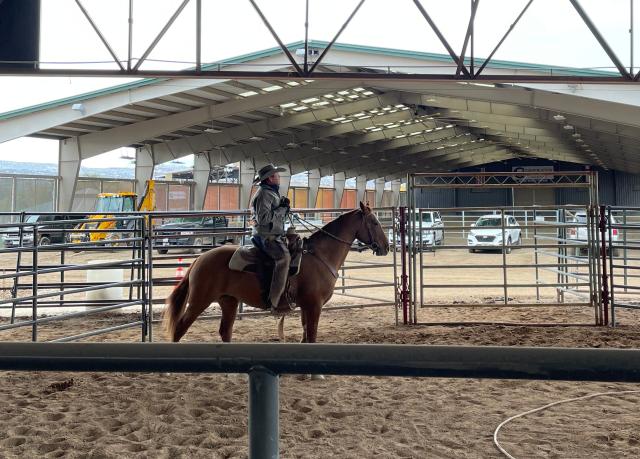 A horse trainer sits on his horse.