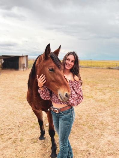 Woman hugging horse. 