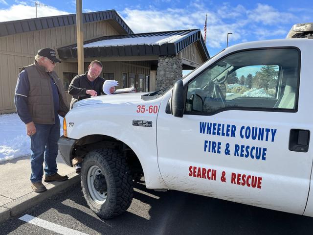 Richard signs the final transfer paperwork with BLM Engine Captain James Holmly before accepting keys to the water tender