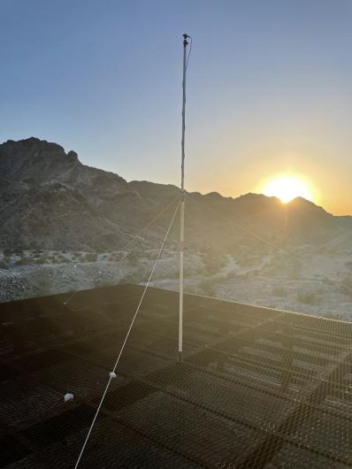 Bat acoustic monitoring equipment (pole with three strings and microphone attached to the top) on top of the Queen Mine Cupola (bat gate) before sunset.