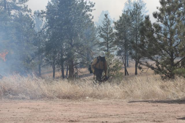 In the course of a day's burn, firefighters will typically walk more than 10 miles, over rough terrain, to ensure they maintain maximum control during each moment of operations. (Photo courtesy of the BLM)