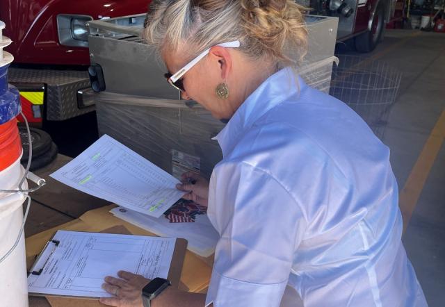 A person sitting at a desk focused on paperwork.