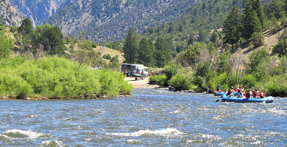 A raft floating down a scenic river.