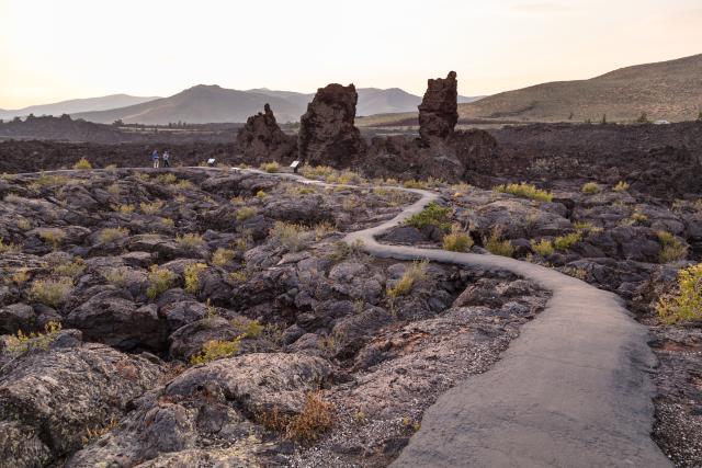 Hikers on North Crater Flow Trail at sunset