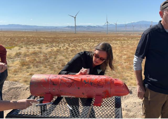 Gloria Tibbetts signs shoe that was later installed at Fervo site on Oct. 9, 2023.