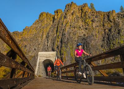 three cyclists in a line on  the Bizz Johnson trail