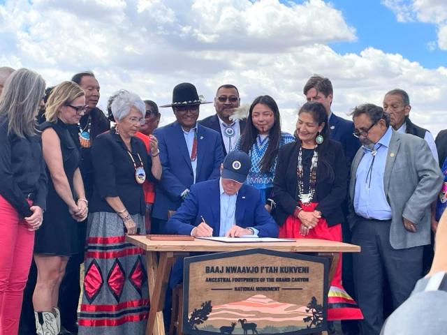 Partners and stakeholders look on as President Joe Biden signs the presidential designation of the Baaj Nwaavjo I’tah Kukveni National Monument.