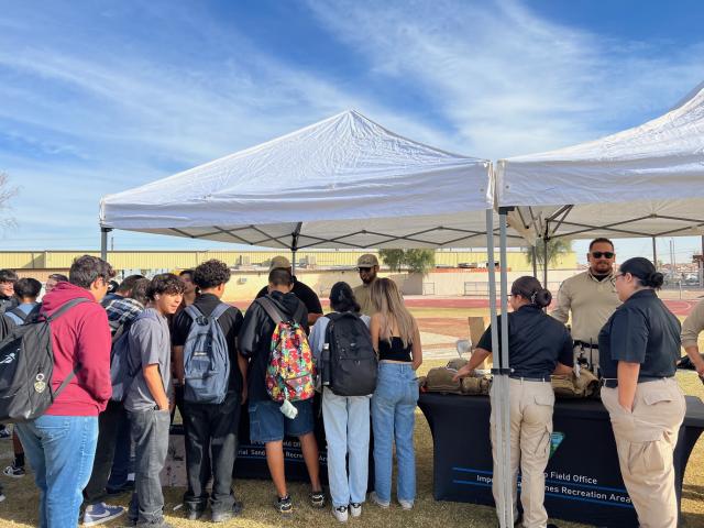 BLM staff speak with students at booth from left, Park Ranger Lead Michael Mujica in a black shirt, Park Ranger Damian Montano and Law Enforcement Ranger Alfonso Luquin. Photo by Arturo Casarez BLM. 