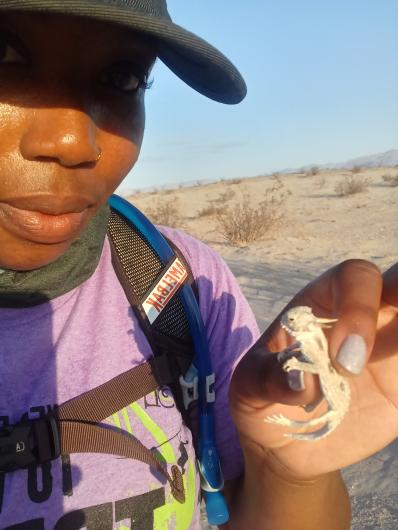 Alexia Williams holds a lizard in her hand.