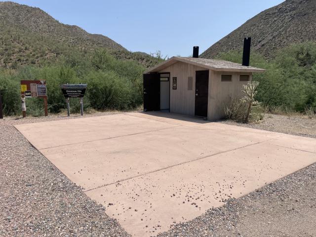 A paved area in front of an accessible bathroom.