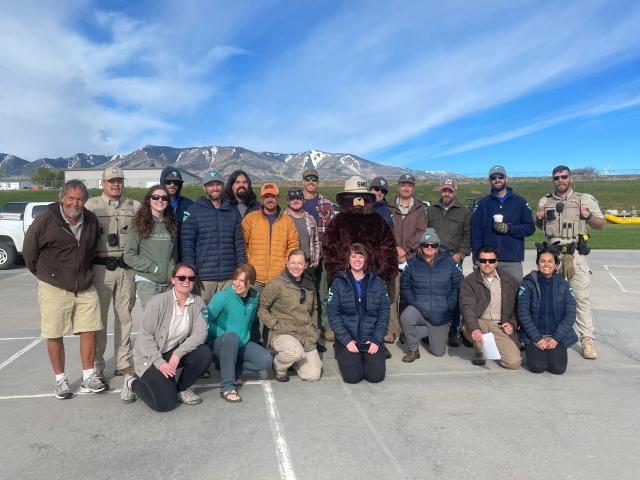 BLM employees pose with Smokey Bear.