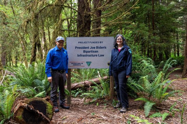 Karen Kelleher and Gordon Toevs by a BIL sign.  