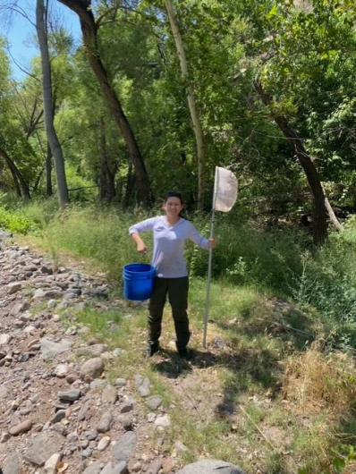 Malissa holds a net and a bucket