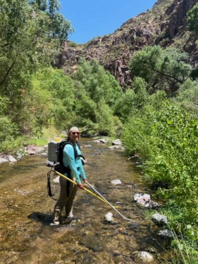 Malissa carries a backpack electrofisher