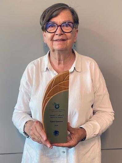 BLM Colorado State Botanist and BLM Threatened and Endangered Species Program Lead Carol Dawson holding her Edward T. LaRoe III Memorial Award from the Society for Conservation Biology