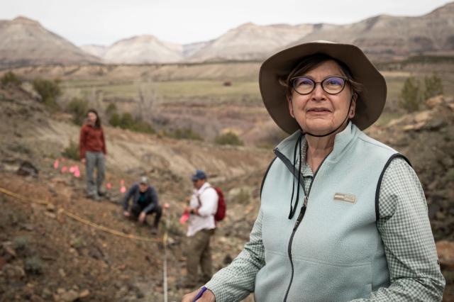 BLM Colorado State Botanist and BLM Threatened and Endangered Species Program Lead Carol Dawson wearing a brimmed hat oversees a team of people sampling of a Sclerocactus dawsoniae, in Debeque, Colorado.