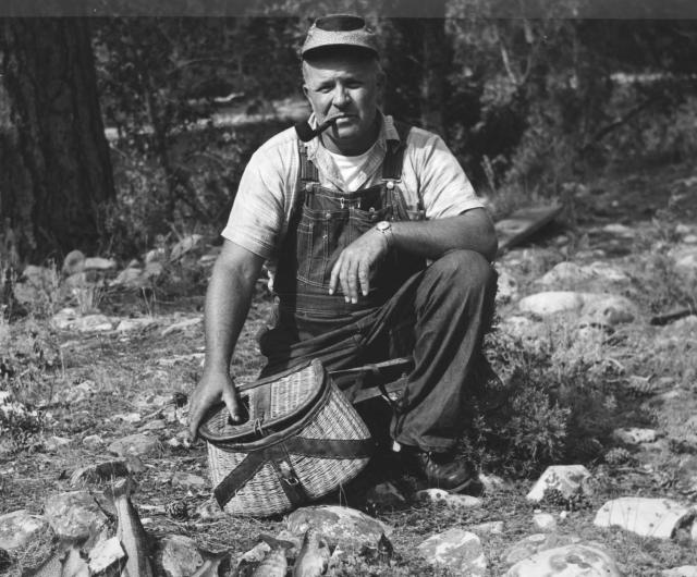 Man examining the day's fish catch, from BLM Library Photo Collection