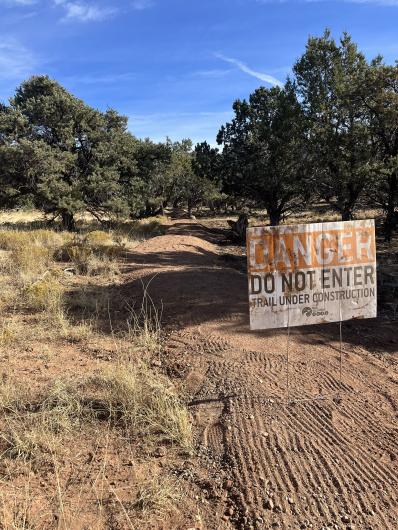 a construction sign on a trail