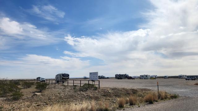 Campers parked under a vast New Mexico sky at Chosa Campground.