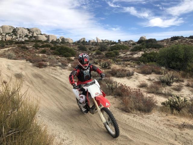 Neil Hamada on a dirt bike in the desert