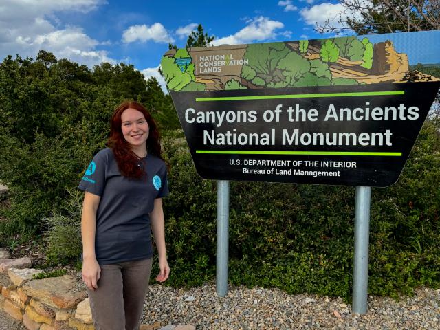 Macy Robinson in front of CANM sign