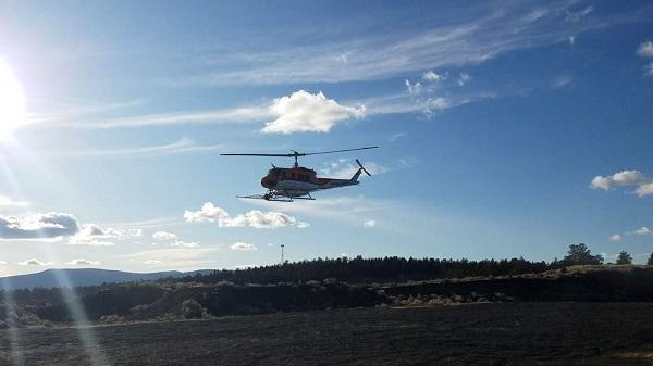 helicopter conducting an aerial herbicide spraying operation