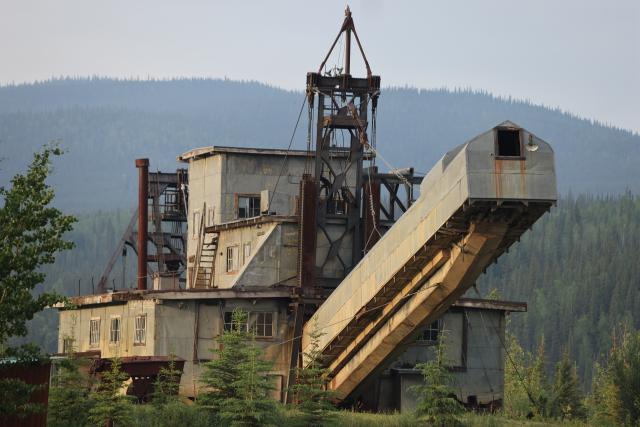 Photo of facility along Fortymile River in front of low mountains.