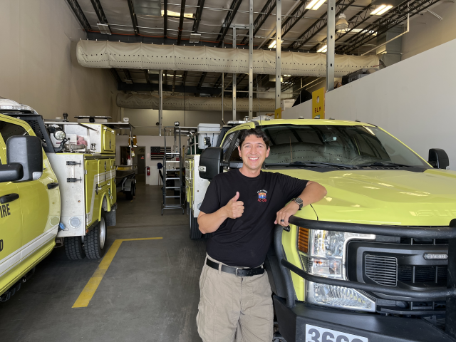 Luis Lopez in front of BLM fire vehicles