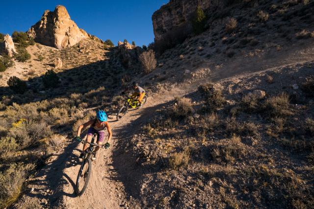 two mountain bikers on a desert trail