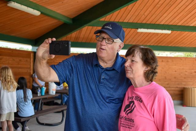 Michael McGee takes a photo with Cheryl Martinez, troop leader. They have worked together on NPLD projects for 20 years.