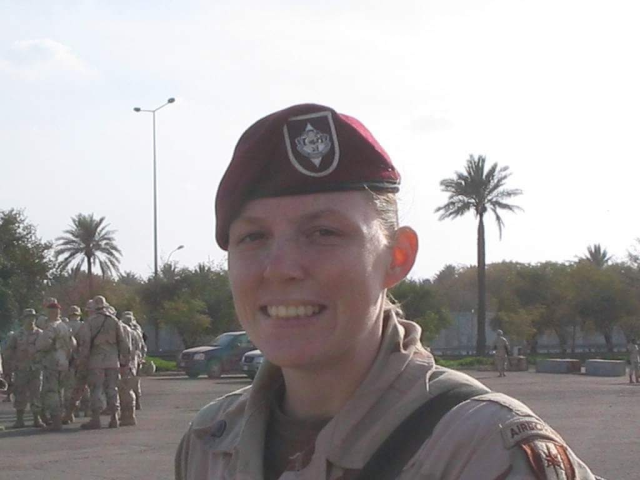 Annie in uniform in foreground with monument in the background