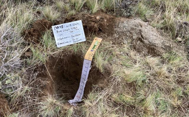 A hole in the ground, with measuring equipment